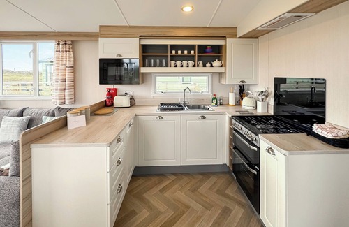Castle Douglas House | 12ft-wide caravan situated in a coastal position.