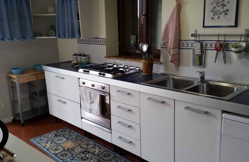 Torgiano Villa | A farmhouse nestled among gardens and olive trees