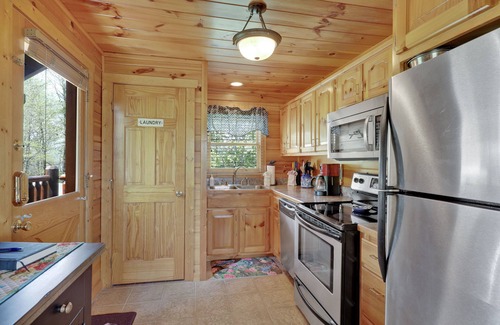 Gatlinburg - Pigeon Forge Cabin | A Taste Of Honey is a dog-friendly two-bedroom true-log cabin nestled inside the Starr Crest resort.