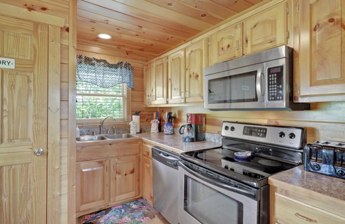 Gatlinburg - Pigeon Forge Cabin | A Taste Of Honey is a dog-friendly two-bedroom true-log cabin nestled inside the Starr Crest resort.