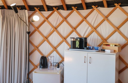 Palm Beach Cabin | Awaawa Yurts - Tane Yurt - Awaawa Yurts offer a luxury glamping experience on Waiheke Island. Stunning views, luxury queen sized bed, private bathroom with tea and coffee making facilities.