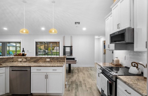 Pelican Villa | Canal-Front Oasis: Pool, Games, EV Charger