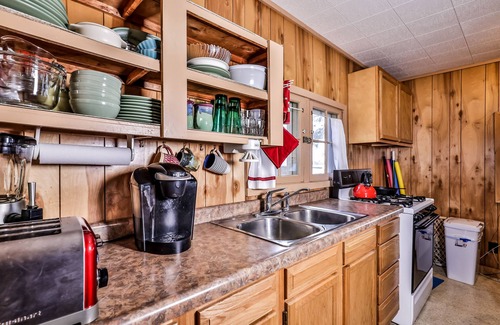 Three Lakes House | Charming, dog-friendly, lakefront cottage with boat dock, grill, & firepit