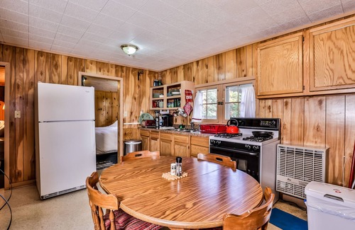 Three Lakes House | Charming, dog-friendly, lakefront cottage with boat dock, grill, & firepit