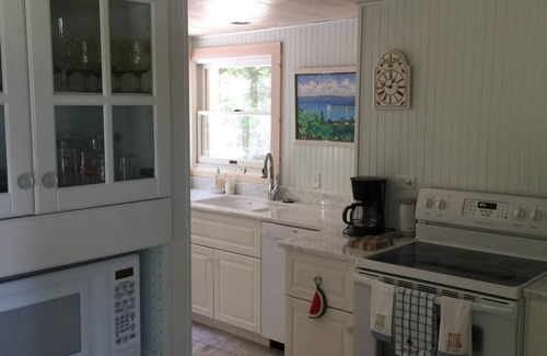 Menonaqua Beach Cottage | Charming Harbor Springs cottage right on the sandy beach and crystal water