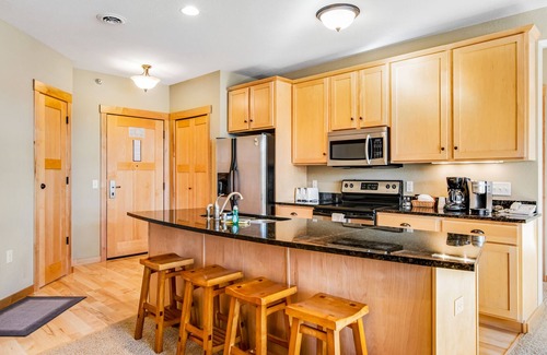 Three Lakes Condo | Charming lakefront condo with pool, fireplace, hot tub, golf, & washer/dryer