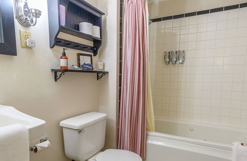 Stowe Bed & Breakfast | Comfortable room with queen bed and daybed with windows on 3 sides, a stunning view of Mount Mansfield and a parlor stove with full service breakfast included