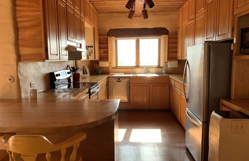 Tyrone House | Escape a cold winter in our large passive solar adobe home with 4 gentle seasons
