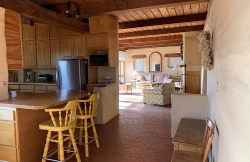 Tyrone House | Escape a cold winter in our large passive solar adobe home with 4 gentle seasons