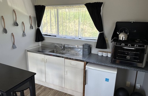 Pukekawa Cabin | Farm Shack with 5-Star River & Sunset Views