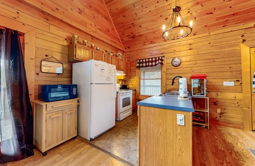 Sevierville Cabin | Forest-view cabin with pool, hot tub, fireplace, deck, & free attraction tickets