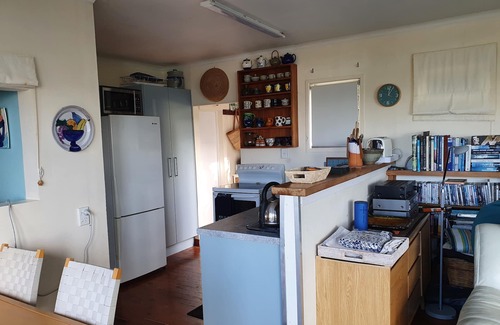 Mahurangi West Cottage | Iconic New Zealand beach cottage with elevated harbour and bush views.