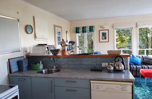 Mahurangi West Cottage | Iconic New Zealand beach cottage with elevated harbour and bush views.