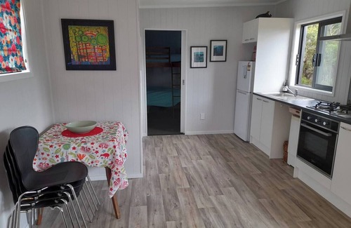 Mangonui House | Itzy Bitzy house is colourful, cosy, fully fenced with sea views