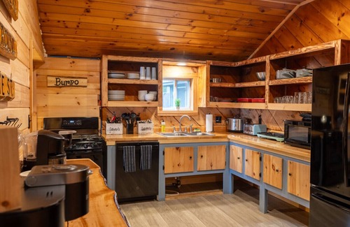 Northeast Somerset Cabin | Katahdin - Cabin 4 · Lawrence`s Lakeside Cabins | `Katahdin`: Boat Dock + Kayaks