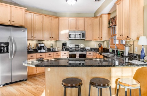 Three Lakes Condo | Lakefront, ground-floor condo with fireplace, patio, private grill & firepit