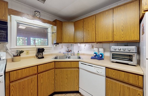 Greenville Junction House | Lakefront Home with Private Dock, Pebble Beach & Enclosed Porch - Dogs Welcome