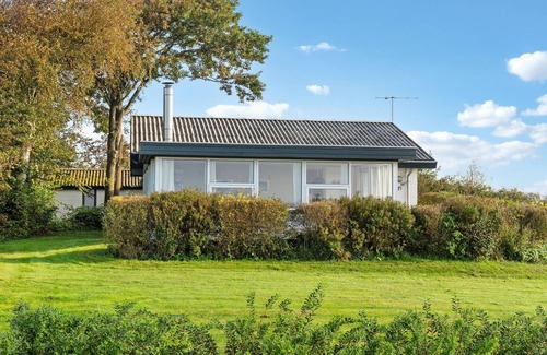 Skyum House | Look forward to a wonderful vacation in this vacation home with green surroundings and sea view.
