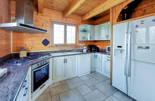 Anould House | Look forward to this large and authentic wooden chalet with an outdoor hot tub.