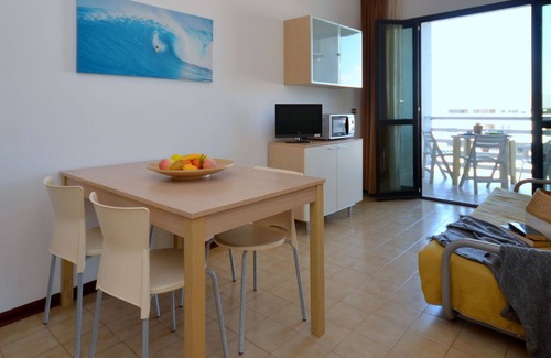 Lignano Sabbiadoro Apartment | Lovely apartment for 4 guests with pool, A/C, TV, terrace, pets allowed and parking