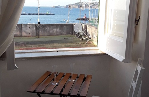 Procida House | MARGIE HOUSE SEAVIEW ROOM Quadruple room with a sea view of Procida harbor.