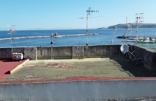 Procida House | MARGIE HOUSE SEAVIEW ROOM Quadruple room with a sea view of Procida harbor.