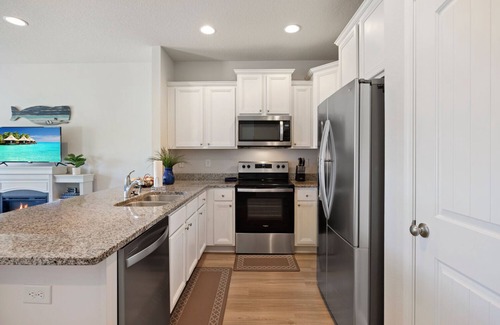 Thomas Drive House | Modern 3BR Townhome | Pool Access | Near Publix Sports Park & Beaches | Sleeps 9