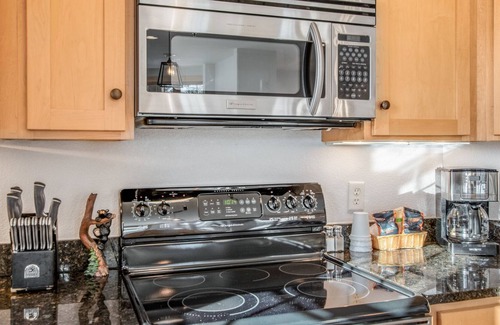 Three Lakes Condo | Modern lakefront condo with grill, W/D, gas fireplace, indoor pool, & hot tubs