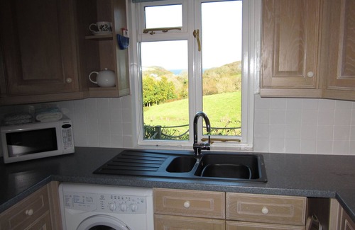 Helford Passage Cottage | Nanteague - quirky luxury chalet-style cottage, sea views across a wooded valley