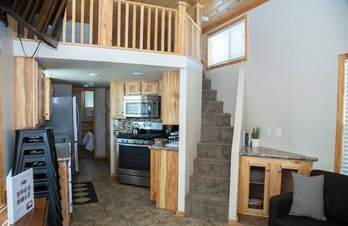 Meeker House | Our largest "not so tiny" tiny home, White River Casita is a beautiful modern tiny home that features a Queen bed on main level, one Queen bed in loft accessible by stairs, one Queen fold out couch with additional sleeping space in loft for sleeping