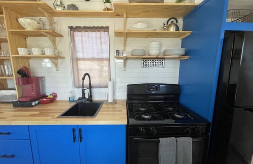 Meeker House | Our newest and one of our largest tiny homes contains a queen bed on the main level and two queen lofted beds. Sleeps: 6