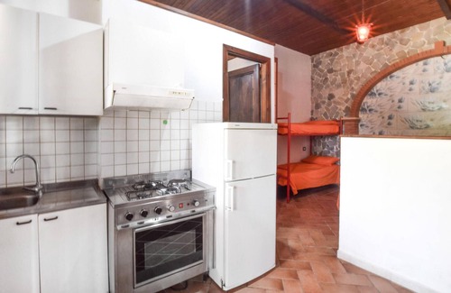 Praia a Mare Apartment | Practical apartment with open terrace and communal pool.