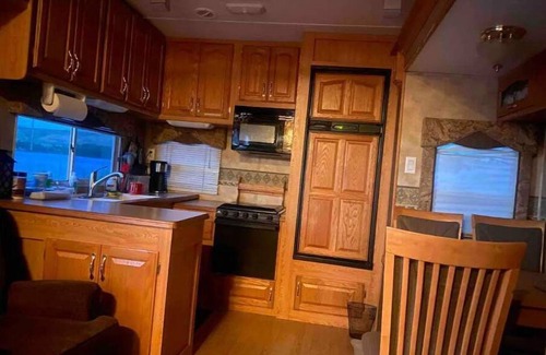 Swanlake House | Queen and twin bed Trailer on private beach, Hammocks, tiki torches, fishing