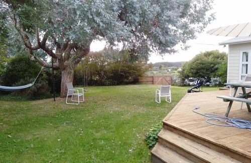 Waitarere Beach House | Renovated oasis with large deck and leafy privacy