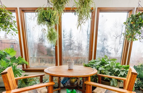 Rabbit Creek House | Secluded retreat with lush sunroom, scenic deck, fireplace & W/D