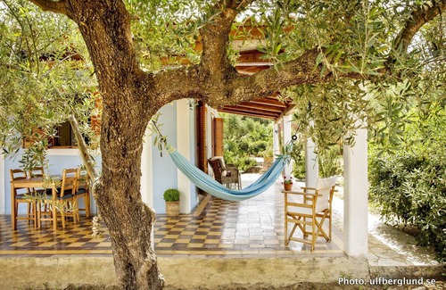 Vasilikos Cottage | Self catered cottage with large veranda and garden with hammock near the beach.