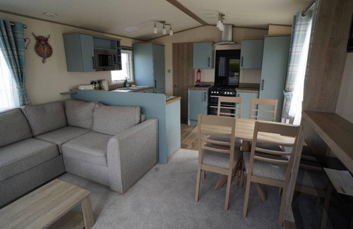 Heacham Ski Chalet | Stunning river view 2 bedroom caravan with decking
