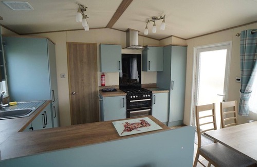 Heacham Ski Chalet | Stunning river view 2 bedroom caravan with decking