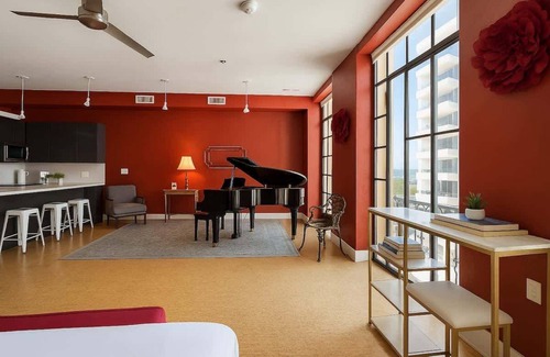 Downtown Dallas Apartment | The Red Room. Double King Bed. Grand Piano