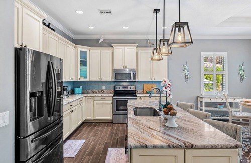Cocoa Beach House | Tropical Backyard Oasis w/ Screened in Outdoor Patio, Pool, Gas Firepit & BBQ Grill!