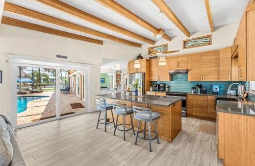 Cocoa Beach House | Tropical Backyard Oasis W/ Dock, BBQ Grill, Heated Pool, & Spa!