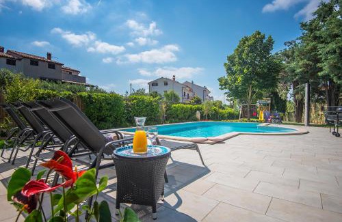 Fazana Villa | Villa Andrija Family Dream with heated pool at the sea with beautiful garden, outside cinema and kids playground