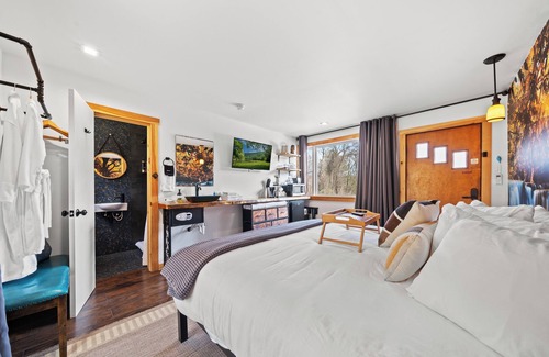 Hancock Hotel | Waterfall Retreat | Serene Room with Forest Mural at Green Acres Retreat