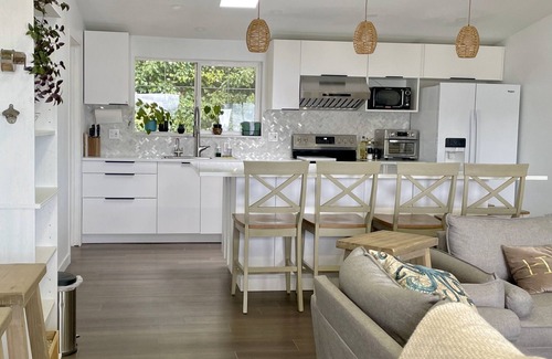 Silverdale House | Waterfront bungalow with 2-bed house and studio connected via spacious deck.