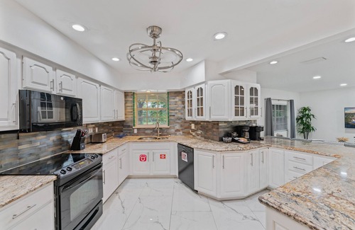 Oakland Park House | Waterfront Retreat: 7BR Villa with Pool & Firepit