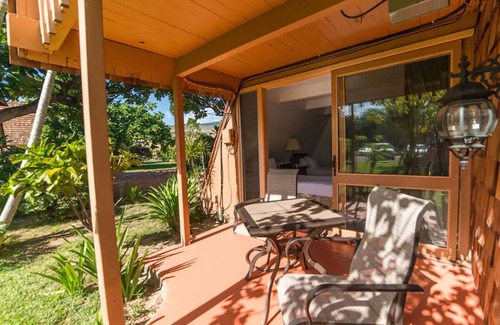 Kaunakakai House | Your Ultimate Oceanfront Retreat | Relaxing Room with Lush Garden View
