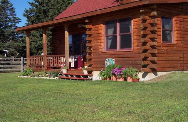 A Log House on a Sand Beach