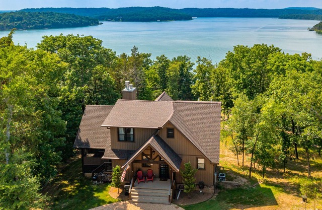 Beautiful 2-story lakefront home with grill, fireplace, screened patio, & views