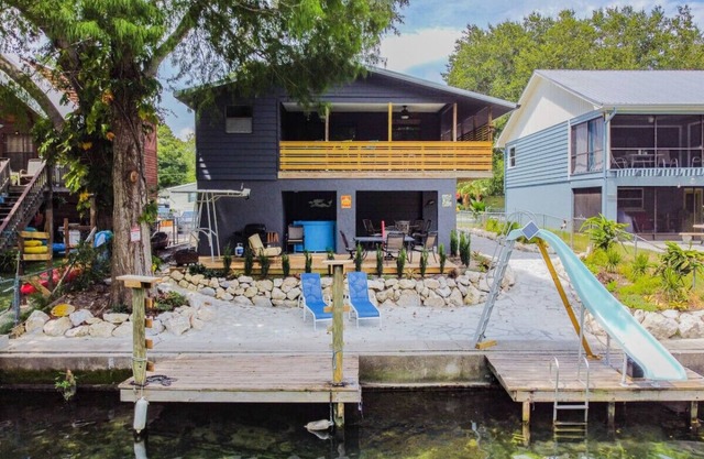 Beautiful Weeki Wachee river house with kayaks, slide, and river views