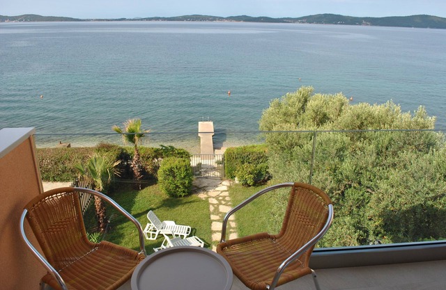 Bright, spacious beach villa with private sea access, jetty and garden